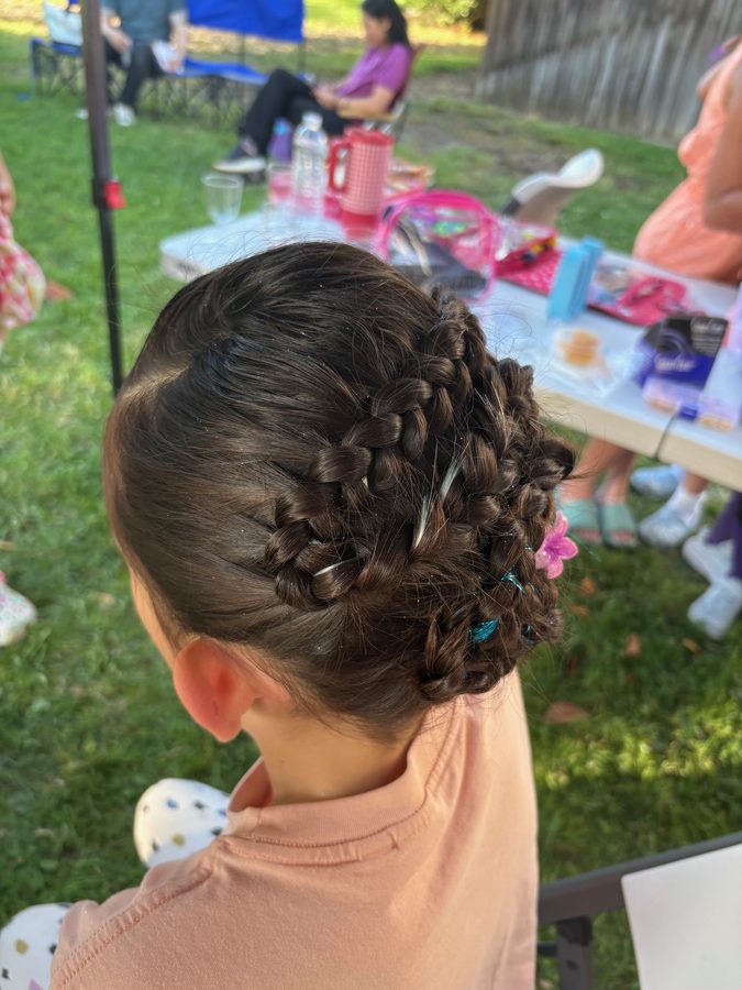 Detailed braided updo with flower